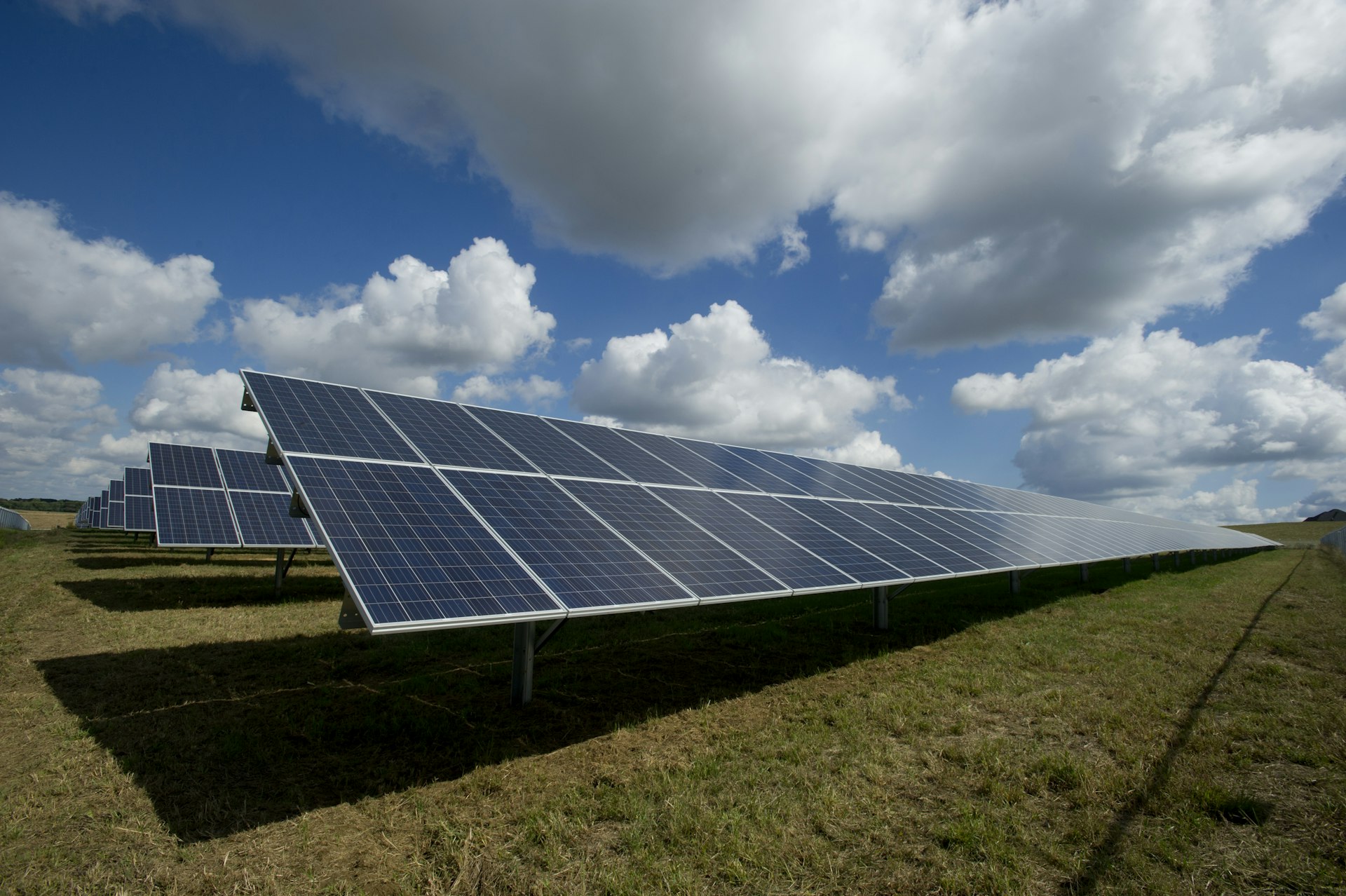 Solar panels and green mountains at sunrise in rural Spain